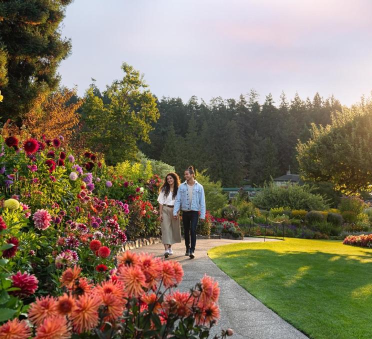 A young couple strolls through The Butchart Gardens in Victoria, BC