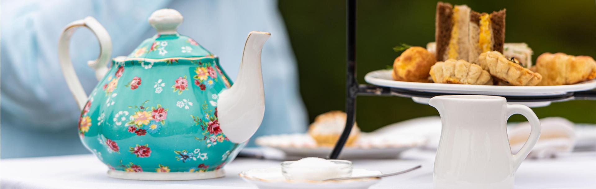 A blue tea pot and a serving of pastries during an afternoon tea service at Abkhazi Teahouse in Victoria, BC