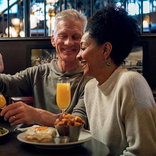 A couple enjoys brunch at the Bard & Banker in Victoria, BC
