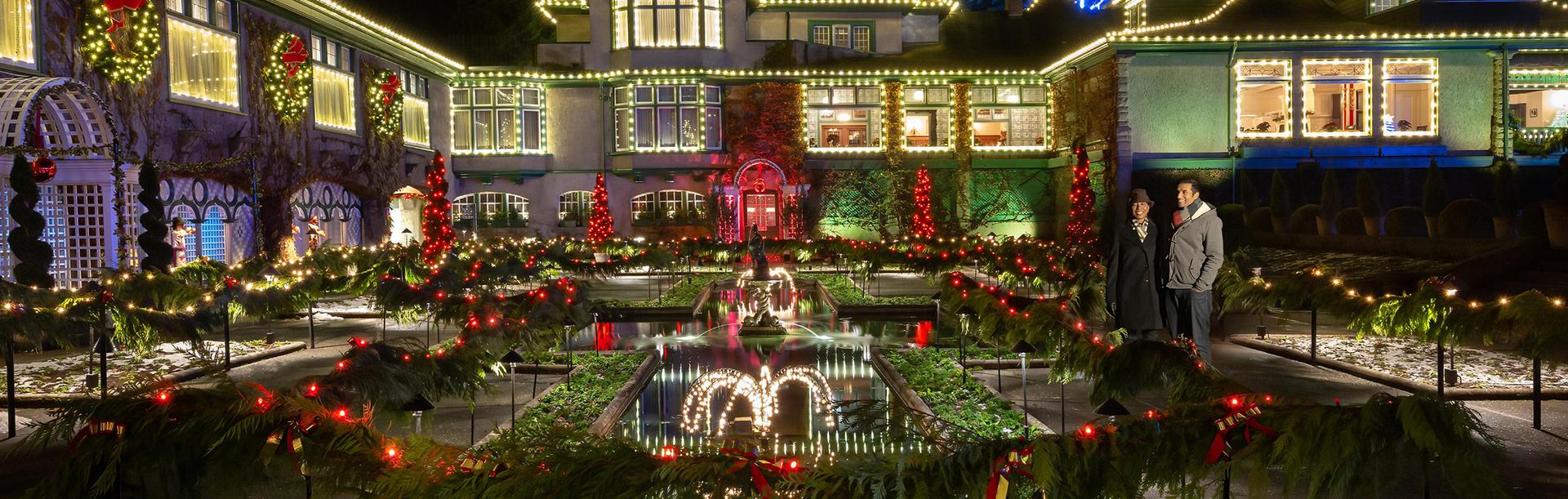 A couple views the fountain at The Butchart Gardens holiday light display in Victoria, BC