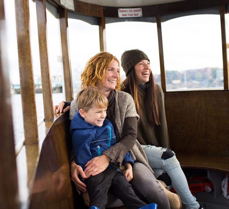 A family enjoys a a Harbour Ferry tour in Victoria, BC