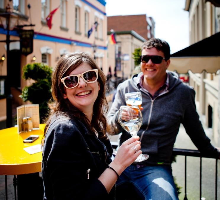 A young couple enjoys a drink on the patio at the Irish Times pub in Victoria, BC
