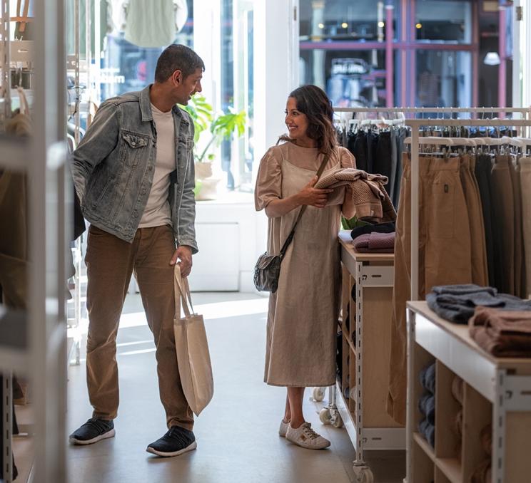 A couple shopping for clothes in a shop on Lower Johnson in Victoria, BC