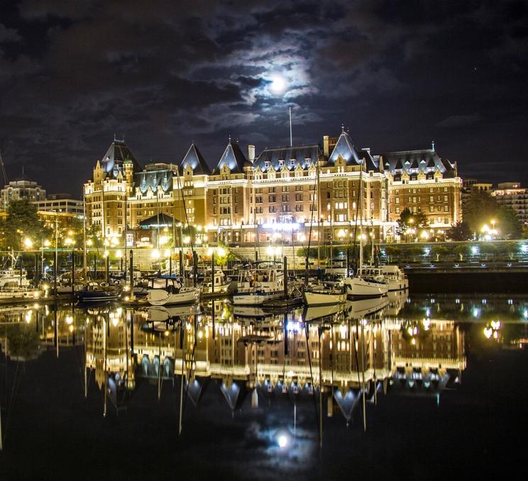 The moon hangs over the Fairmont Empress on Victoria's Inner Harbour