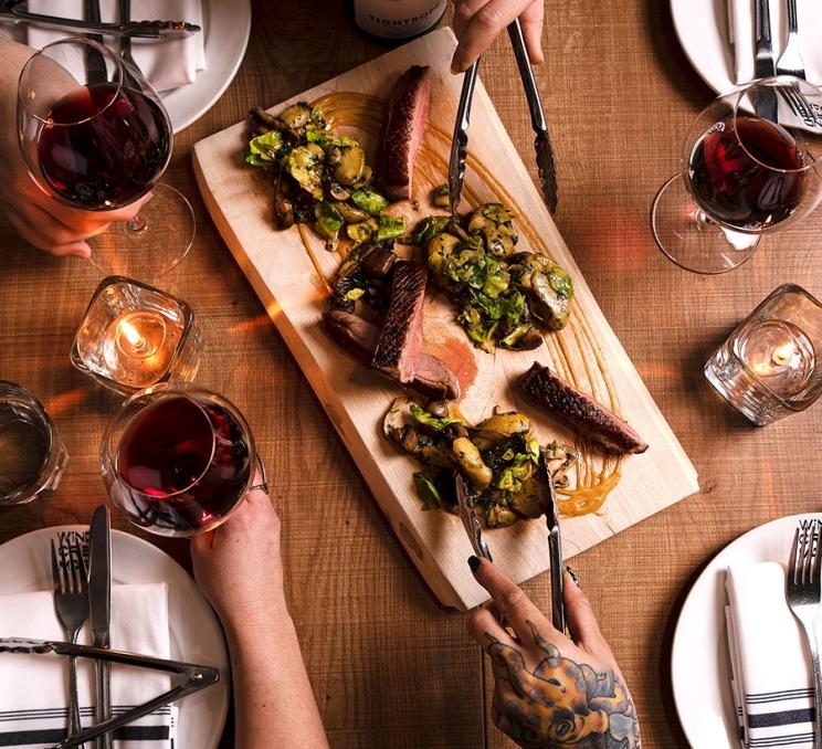 A group dines family style at Wind Cries Mary in Victoria, BC