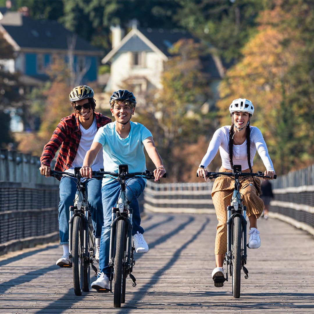 A group of friends ride bikes along the Selkirk Trestle in Victoria, BC