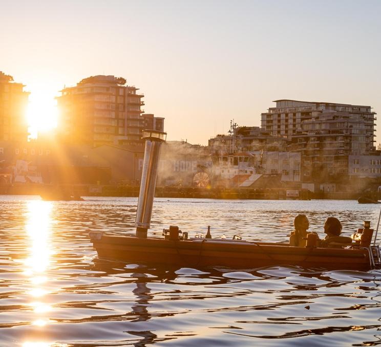 A couple soaks in a Hot Tub Boat as they sail the Upper Harbour in Victoria, BC