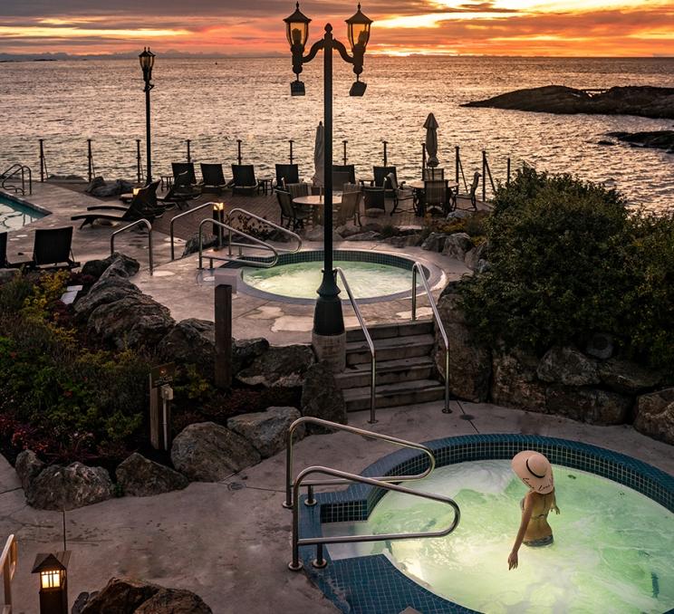 A woman soaks in a seaside mineral pool at the Oak Bay Beach Hotel in Victoria, BC
