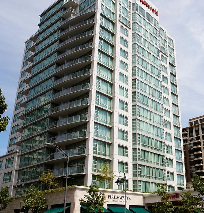 A street-level view of the Victoria Marriott Inner Harbour in Victoria, BC