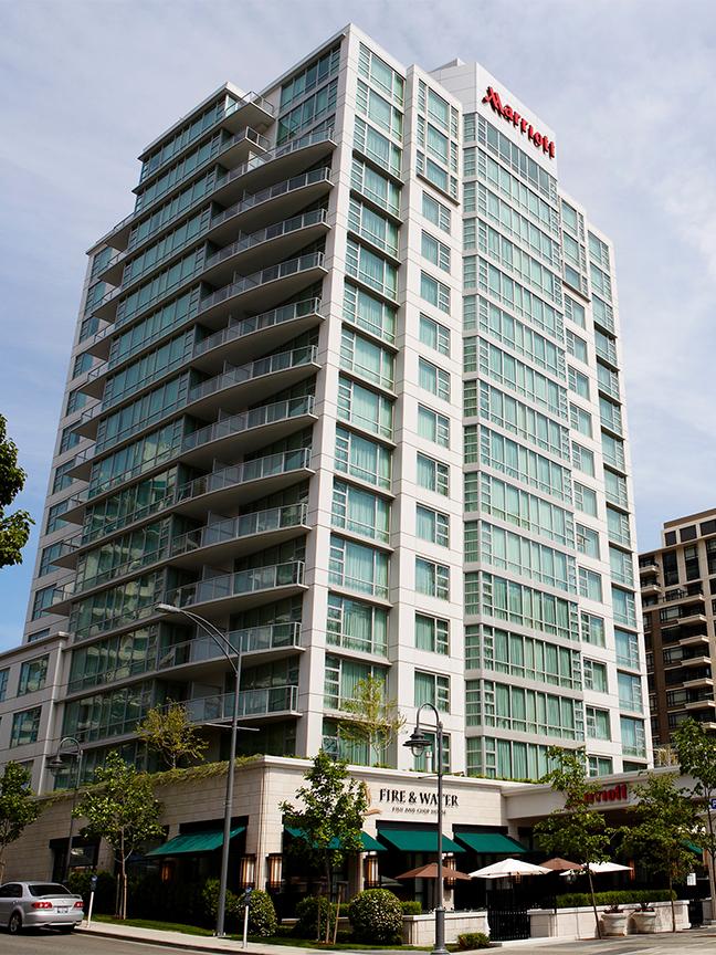 A street-level view of the Victoria Marriott Inner Harbour in Victoria, BC