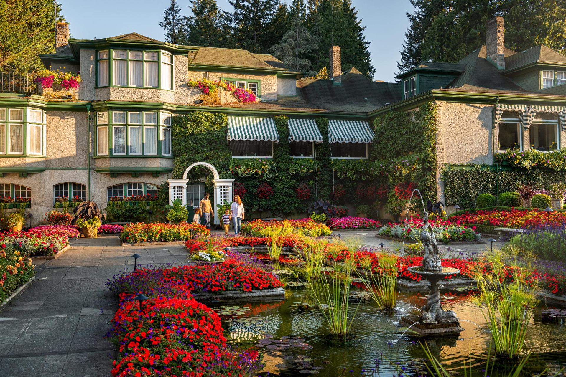 A young family explores the grounds of The Butchart Gardens in Victoria, BC