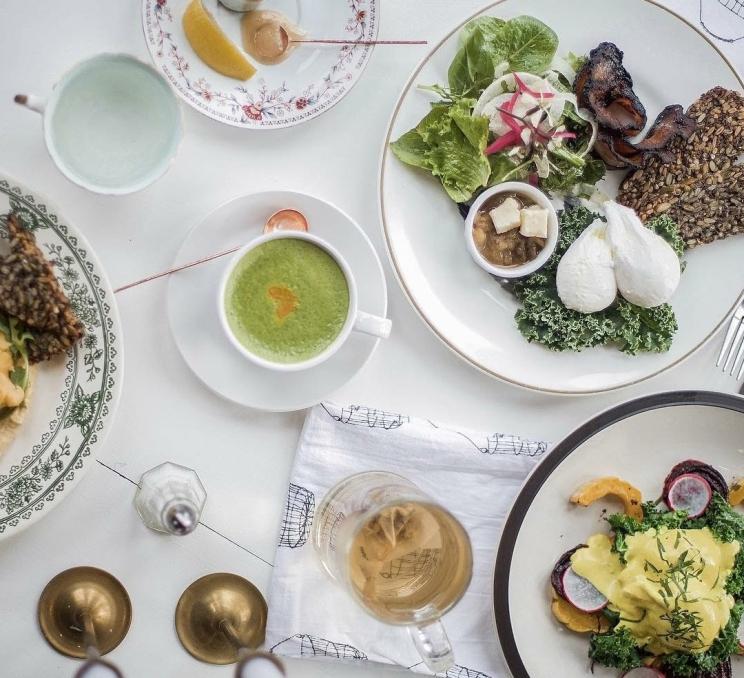 A spread of brunch items and lattes at Nourish Kitchen & Cafe in Victoria, BC