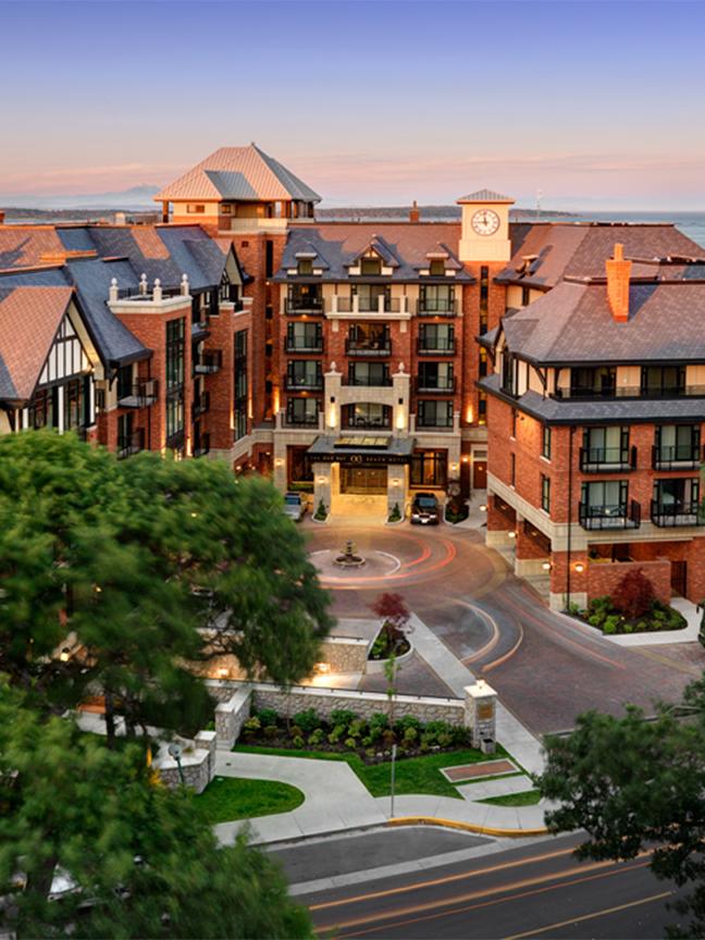 The exterior of the Oak Bay Beach Hotel at sunrise in Greater Victoria, BC