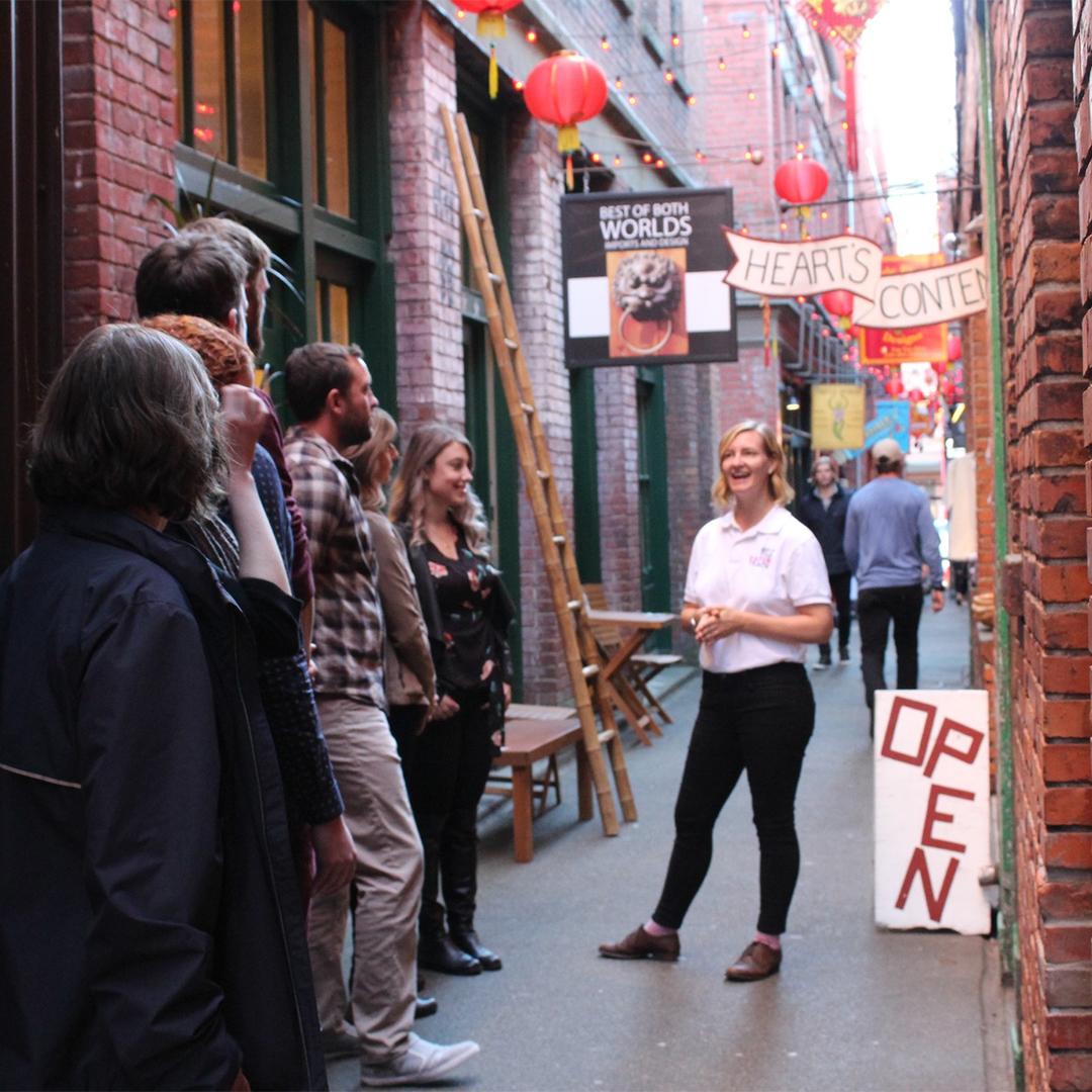 An Off the Eaten Track food tour stops in Fan Tan Alley, Canada's narrowest street, in Victoria, BC's historic Chinatown.
