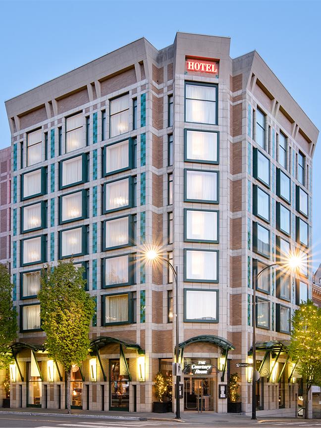 A street-level view of the Magnolia Hotel & Spa in Victoria, BC at sunset
