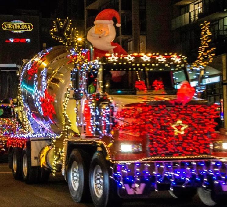 A roller truck decorated in Christmas Lights drives through downtown Victoria during the IEOA Truck Parade