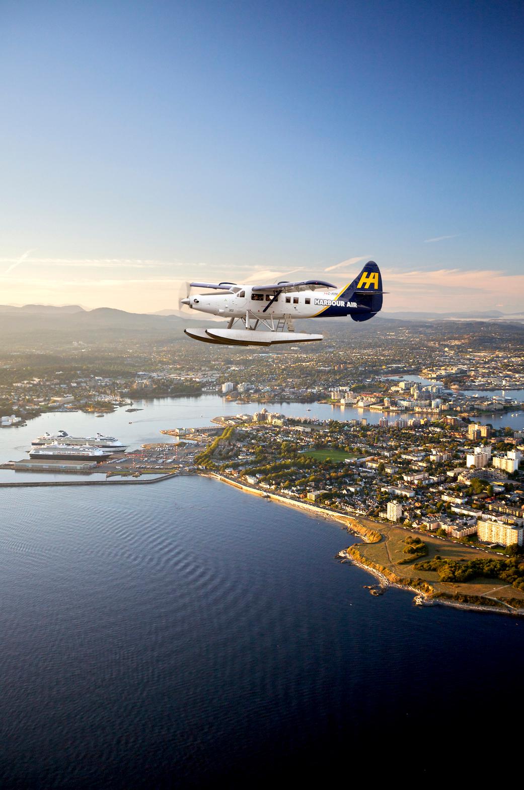 A Harbour Air Seaplanes flight soars into Victoria, BC's Inner Harbour