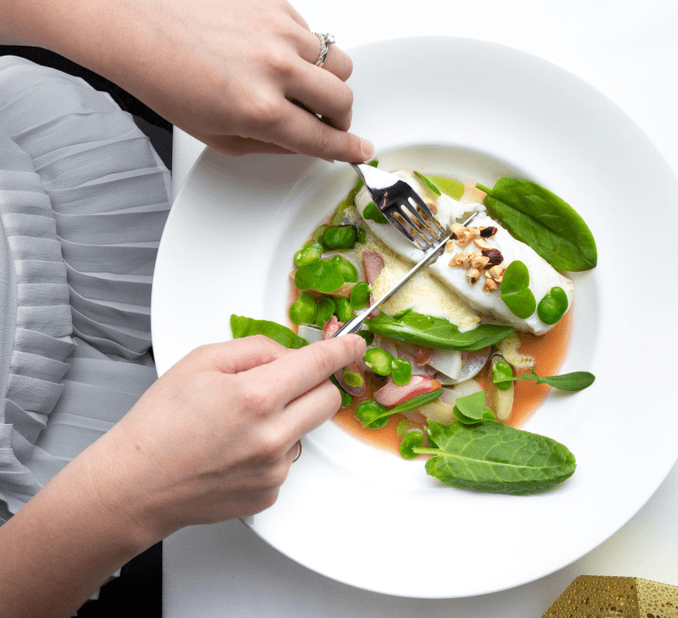 A person slicing vegetables at a Victoria, BC restaurant