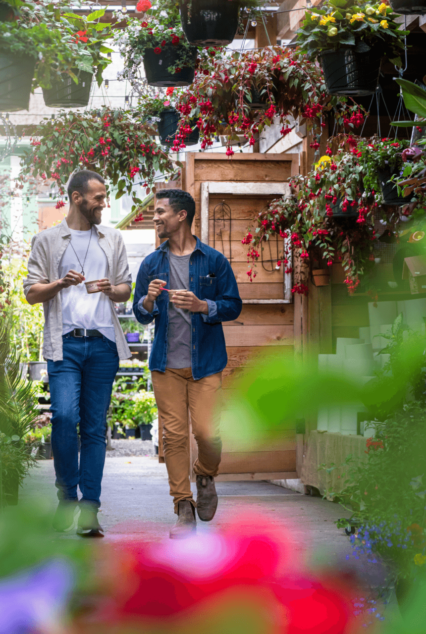 A couple walking through Cook Street Village in Victoria, BC