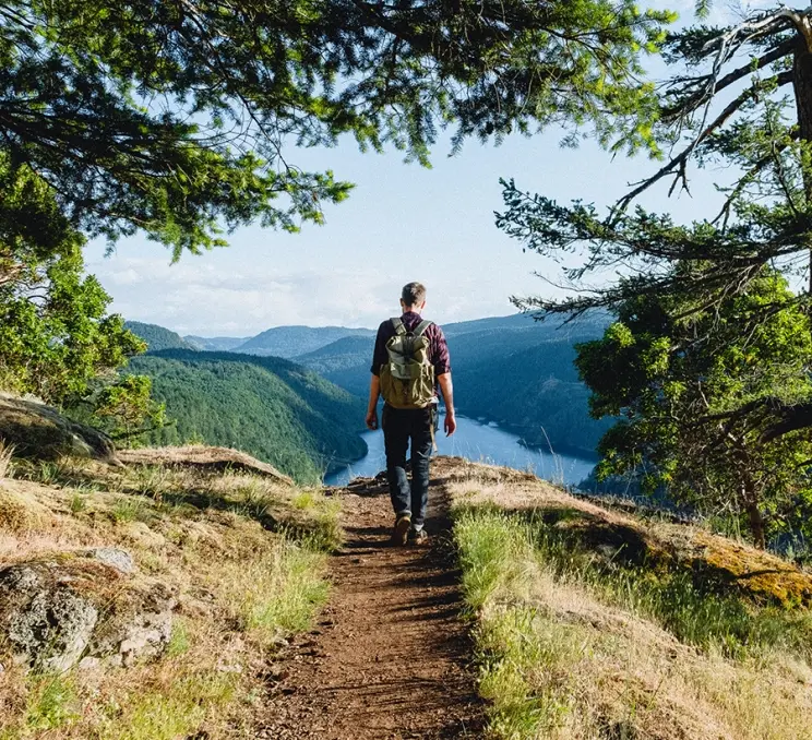 A hiker explores a trail along the Saanich Inlet in Gowlland Tod Provincial Park in Victoria, BC